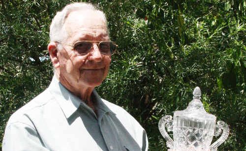 Springsure’s Stan Priddle cradles one of the solid crystal trophies which would have been presented to race day winners. Springsure’s Stan Priddle cradles one of the solid crystal trophies which would have been presented to race day winners.